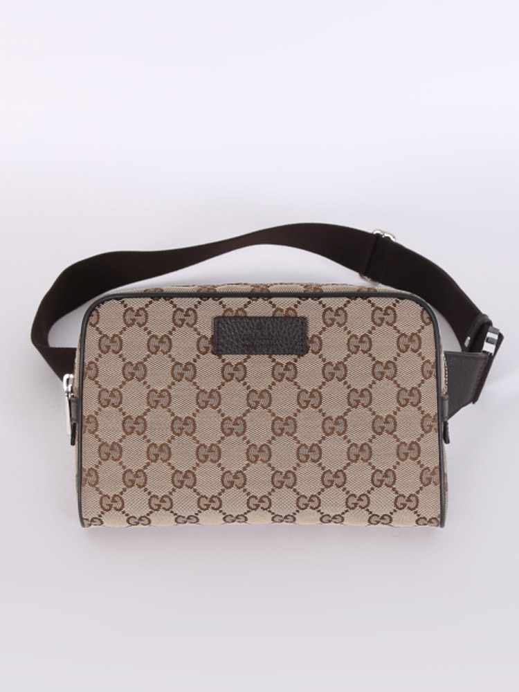 Gucci luxury handbag with belt.